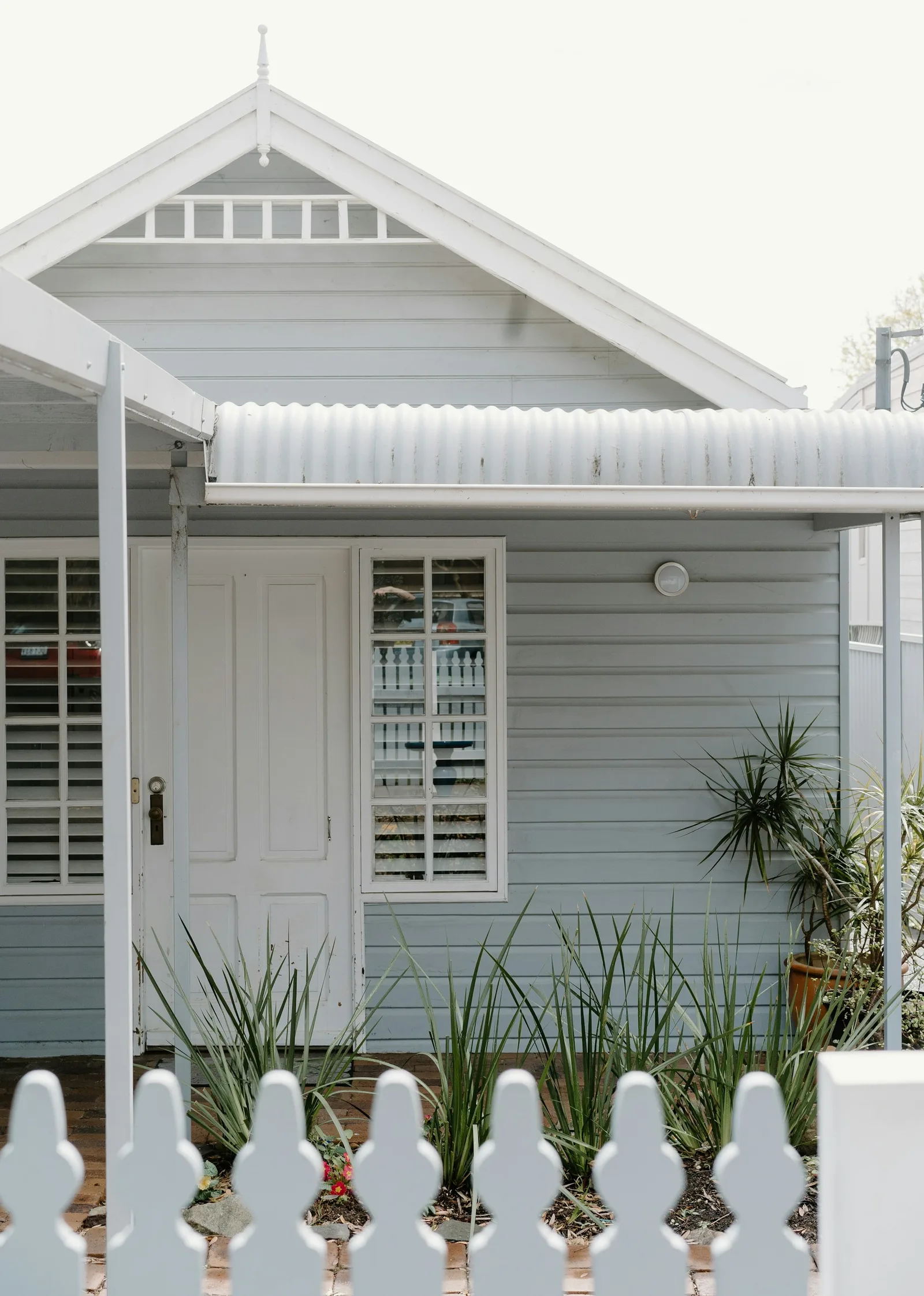 Weatherboard-clad home with white shutters